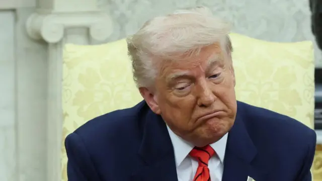Trump shrugs as he speaks in the meeting