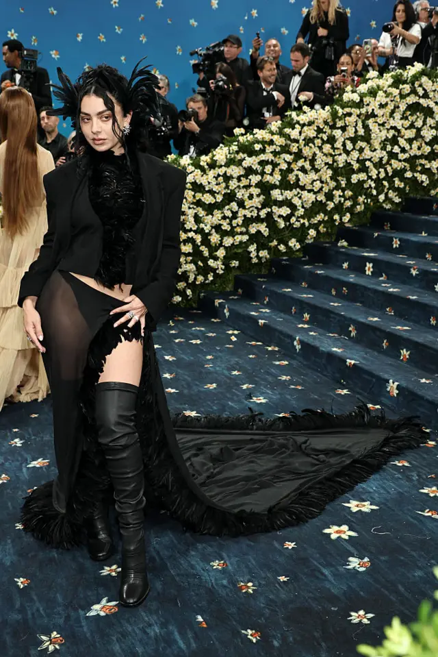 Singer Charli XCX wearing all black boots, shirt and lace