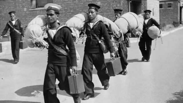 Black and white image of newly-qualified Indian sailors leaving Stamshaw Training Camp in Portsmouth