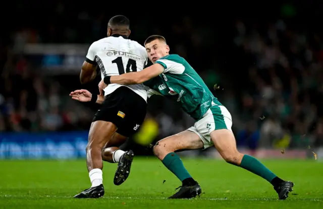 Sam Prendergast of Ireland tackles Jiuta Wainiqolo