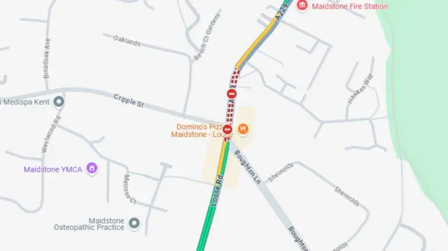 A screenshot of Google maps live traffic map showing two closed signs and red dots along Loose Road
