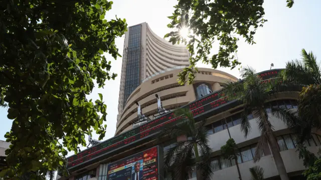People walk past the Bombay Stock Exchange (BSE) building in Mumbai, India, 07 April 2025