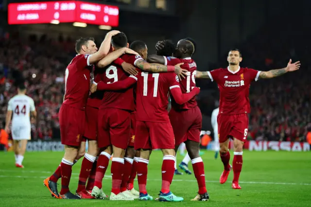 Mohamed Salah of Liverpool is mobbed by teammates after scoring his sides second goal