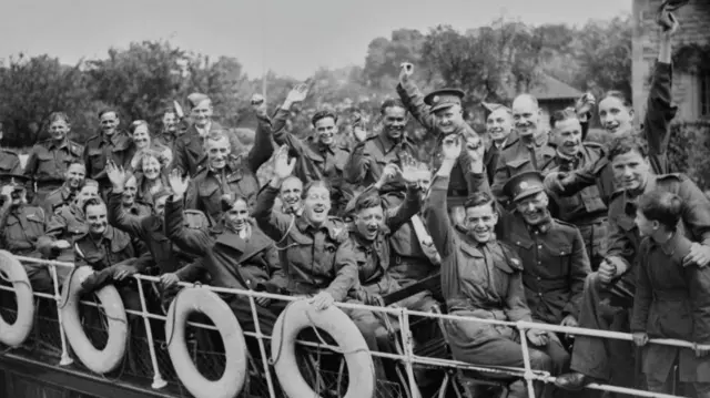 A crowded boat of convalescing wounded soldiers, all waving to the camera during a riverboat trip down the River Thames at Oxford in 1941