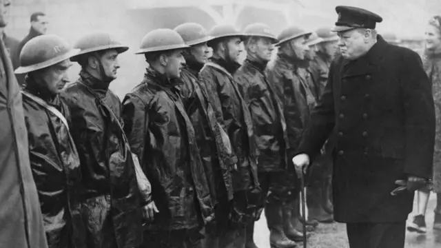 Black and white image of Prime Minister Winston Churchill inspecting members of an Air Raid Precautions (ARP) rescue squad