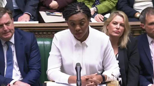 Kemi Badenoch, wearing a white shirt, addresses Keir Starmer in the Commons