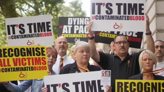 Campaigners gathering in Westminster with placards reading 'It's Time' and 'Recognise all victims of contaminated blood'