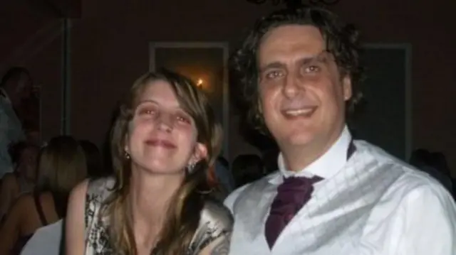 Paul and his wife look to the camera and smile.