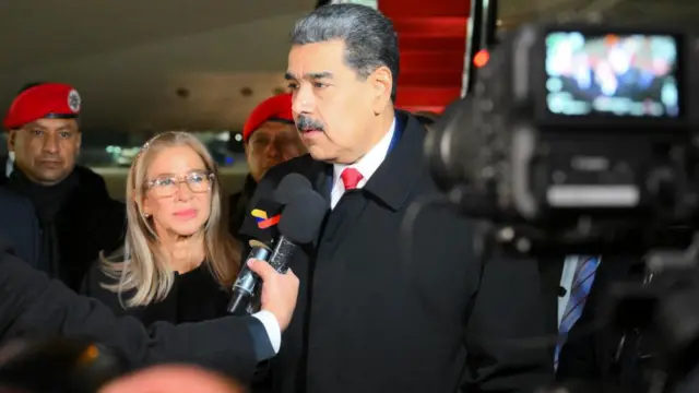 Nicholas Maduro and his wife arrive in Moscow and stand outside the plane and take questions from reporters.