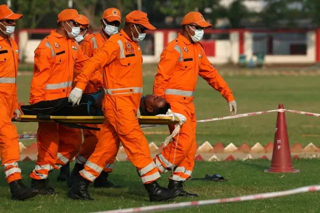 National Disaster Response Force (NDRF) personnel take part in the nationwide civil defence mock drill in Varanasi on May 7, 2025, as border tensions surge. India and Pakistan exchanged heavy artillery along their contested frontier on May 7, after New Delhi launched missile strikes on its arch-rival in a major escalation between the nuclear-armed neighbours. (Photo by Niharika KULKARNI / AFP) (Photo by NIHARIKA KULKARNI/AFP via Getty Images)