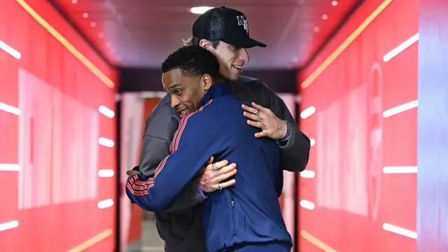 Injured Arsenal defender RIccardo Calafiori hugs (R) Jurrien Timber before the Premier League match
