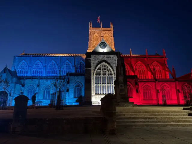 Sherborne Abbey lit up in red, white and blue