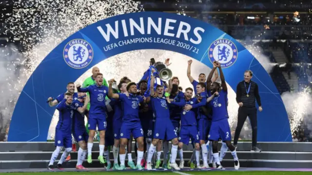 Chelsea players celebrate with the Champions League trophy after winning the 2021 final