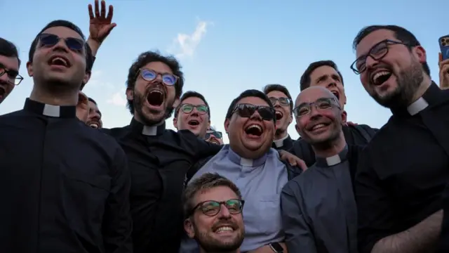 Priests smile and seem to shout after the news was announced