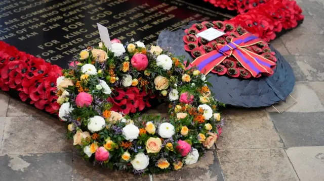 Two wreaths lay on the tomb of the unknown soldier inside Westminster abbey. The tomb is lined with red poppies