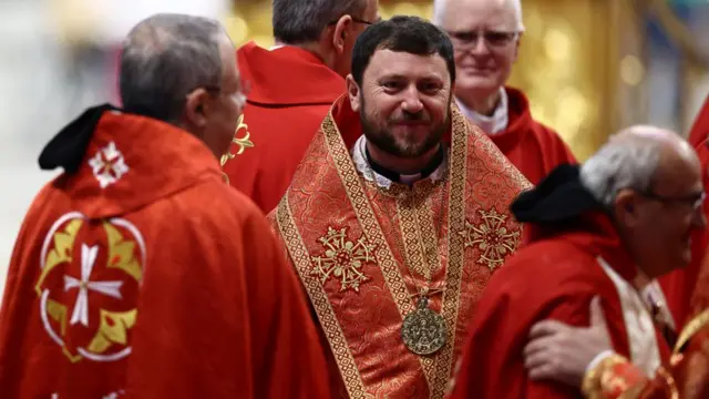 Cardinal Mykola Bychok wears a red and gold adorned robe while attending a mourning mass for Pope Francis at St Peter's Basilica at the Vatican on 2 May 2025.