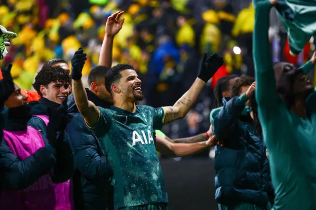 Tottenham Hotspur's English forward #19 Dominic Solanke (C) celebrates with players and fans