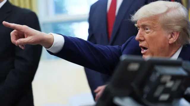 U.S. President Donald Trump takes qu\estions as he makes an announcement about a trade deal