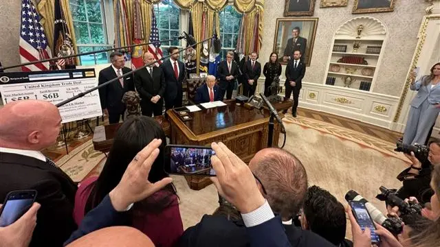 US President Donald Trump (centre) announces the deal the UK Ambassador to the US Peter Mandelson stands to the right of him
