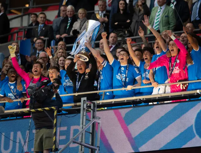 Peterborough United Manager Darren Ferguson and Harrison Burrows of Peterborough United lift the Bristol Street Motors Trophy