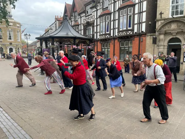 People dressed in 1940s-style clothing dancing in Brigg.