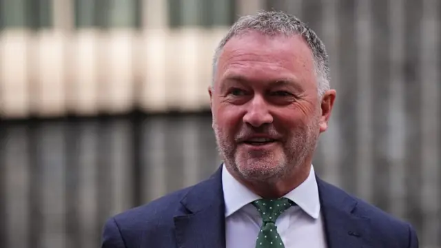 Farming Secretary Steve Reed wears a suit and smiles outside No. 10.