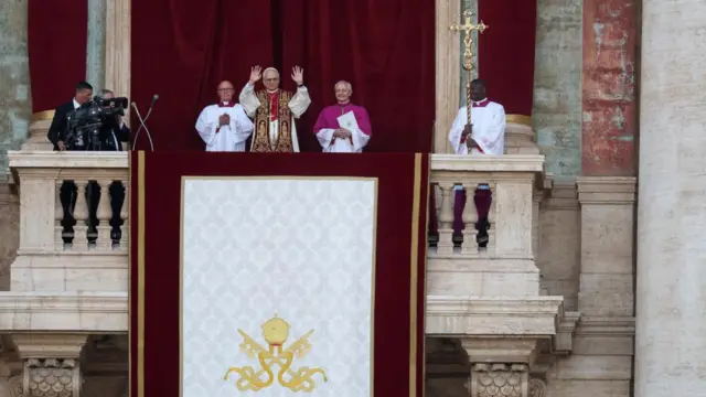 The pope stands on the balcony