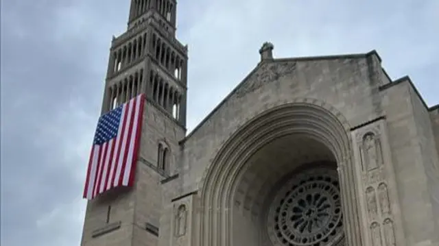 An American flag hangs on the Basilica of the National Shrine of the Immaculate Conception