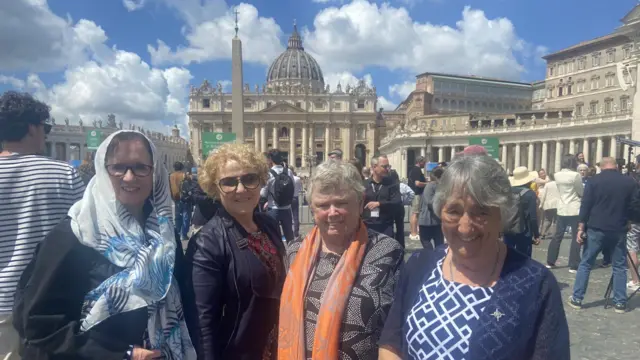 Four women standing and smiling in St Peter's Square