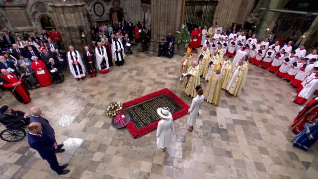 Members of the Royal Family and the clergy stand around the tomb of the unknown soldier after laying wreaths