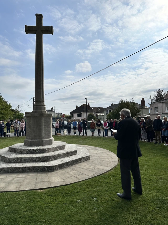 People stood around Bembridge's war memorial as the names of those killed are being read out.