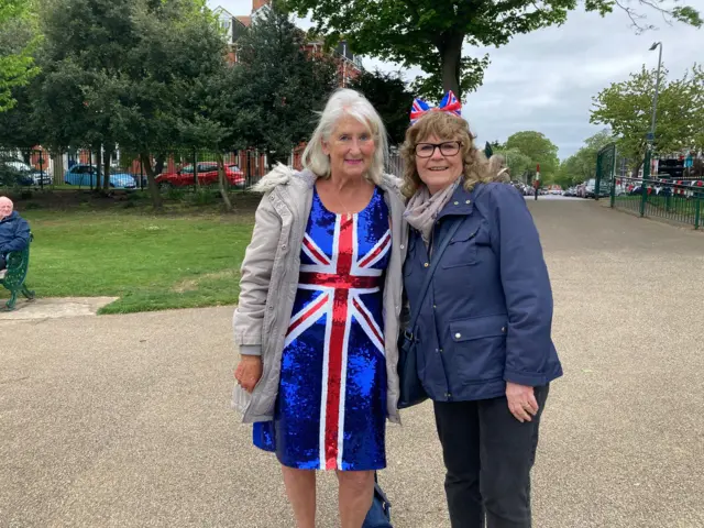 Two women - one dressed in a union flag dress - posing for a picture in Skegness