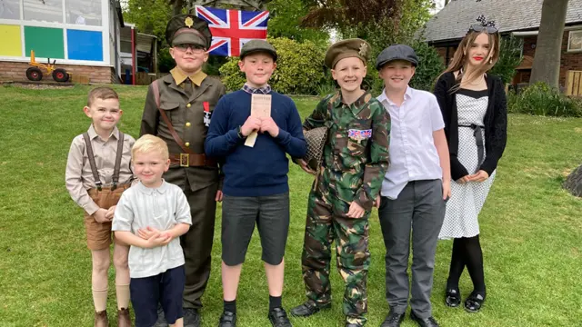 Pupils from wearing military uniforms and civilian clothing Huttoft Primary School