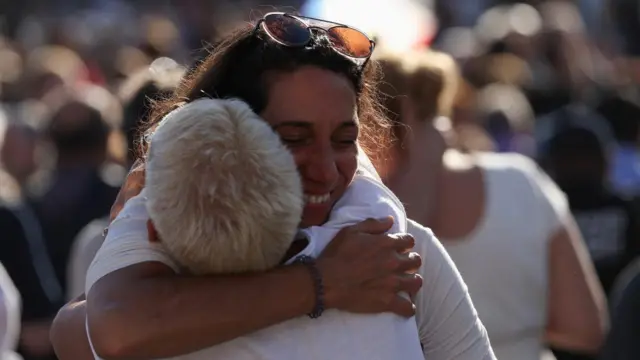 Two women hug after seeing the white smoke to announce a new Pope. -
