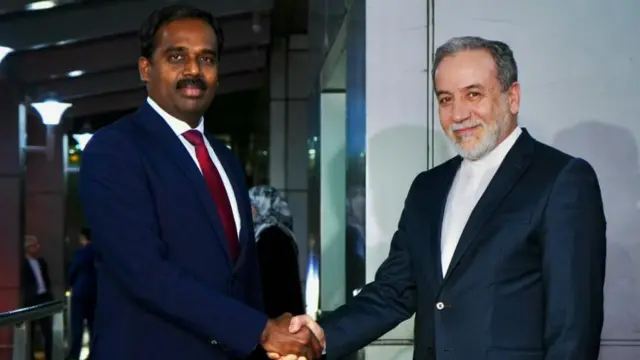 Iranian Foreign Minister Abbas Aragchi seen shaking hands with an India foreign ministry official