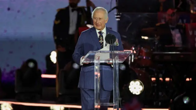 King Charles speaking into a microphone.