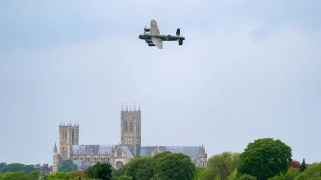 A Lancaster bomber flies over Lincoln Cathedral during the 80th anniversary of the Dambusters raid in 2023