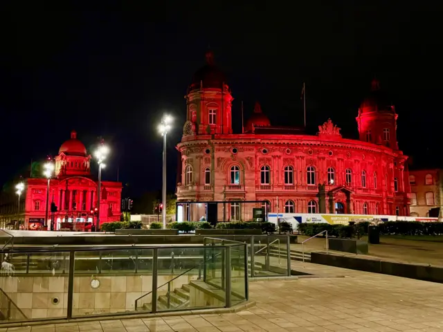 An image Hull Maritime Museum taken from the Beverley Gate in Hull. The building is bathed in red light.