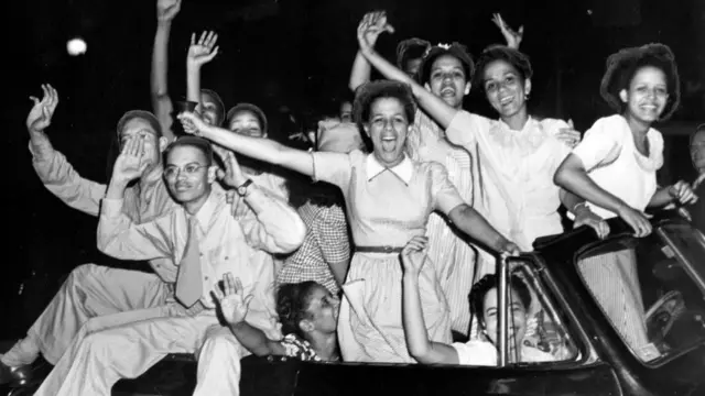 Young Black Americans celebrate the end of World War II in Baltimore. Maryland.