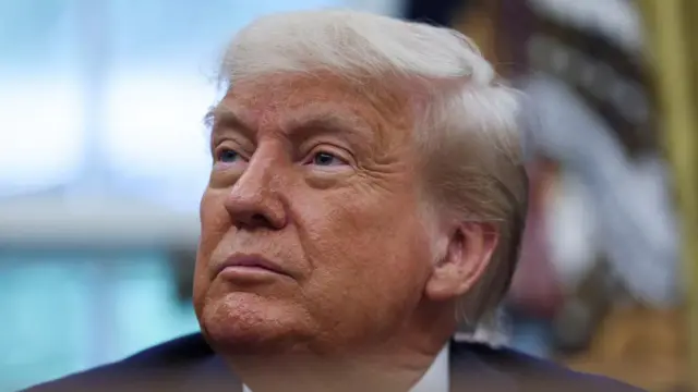 A file photo of Trump, sitting in the Oval Office and looking off camera