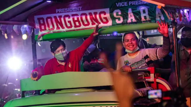 Ferdinand "Bongbong" Marcos Jr., the son of the late dictator Ferdinand Marcos, and Davao city Mayor Sara Duterte, daughter of President Rodrigo Duterte, take part in a rally as they campaign for the presidency and the vice presidency on February 19, 2022 in Caloocan, Metro Manila