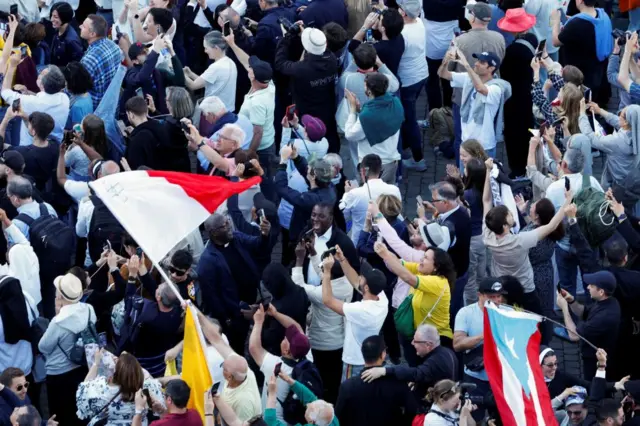 People wave flags, take pictures and celebrate