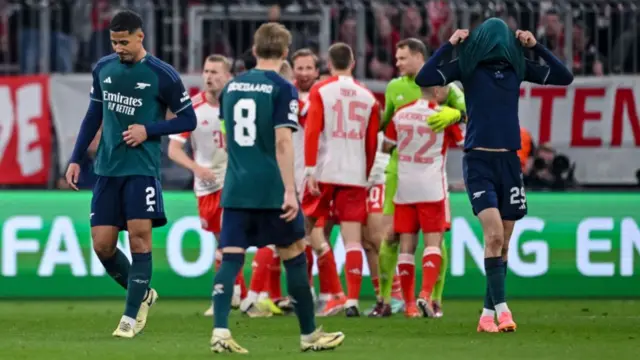 Arsenal players looking disappointed after being knocked out of the Champions League by Bayern Munich in 2024