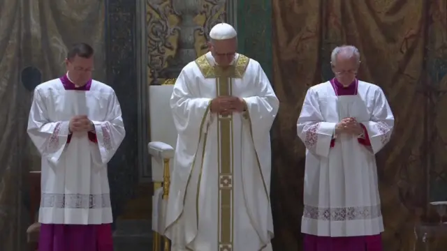 Pope Leo and two other priest bowing their hads and holding their hands together, fingers interlocked