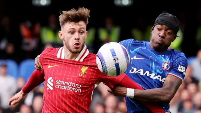 Liverpool's Conor Bradley challenges for the ball with Chelsea's Noni Madueke