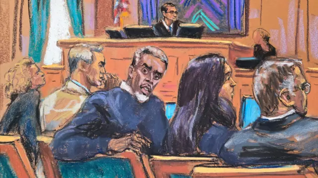Combs, flanked by four members of his legal team, turns to look at the courtroom