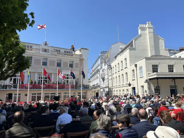 People gathered for a memorial of the SS Vega's service to islanders in the Royal Square in St Helier, Jersey.