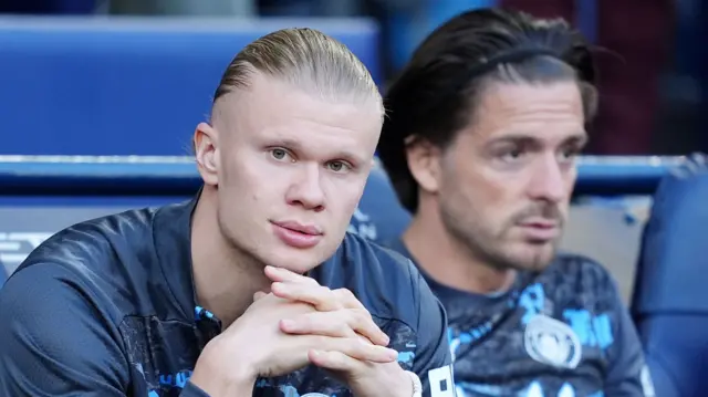 Erling Haaland on the Manchester City bench beside Jack Grealish