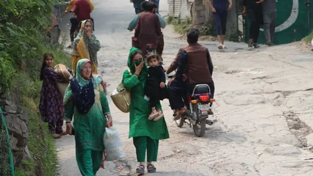 Locals leave the area as UN delegation visits the Shawai area in Pakistan-administered Kashmir to inspect the damaged mosque and surrounding region in Shawai, Muzaffarabad, Pakistan on May 7, 2025.