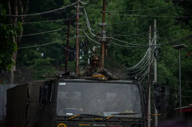 An Indian Army convoy carrying reinforcements and supplies drives near Pakistan-administered Kashmir